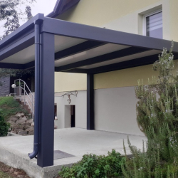 Kovinski nadstrešek Hosekra ob hiši s stranskim žlebom