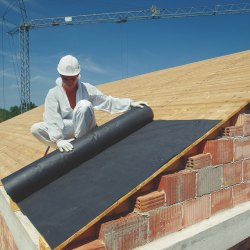 Polaganje črne hidroizolacijske folije na leseno strešno konstrukcijo